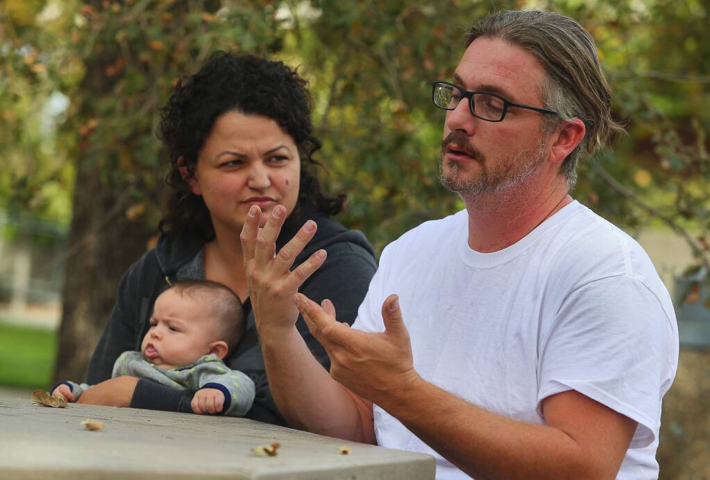 Deaf couple Doug Fischer and Destiny Castellanos, with their three-month-old baby Stone Fischer, recount their escape from their Coffey Park home, with their two daughters. The home they were renting was completely destroyed. (Christopher Chung/ The Press Democrat)