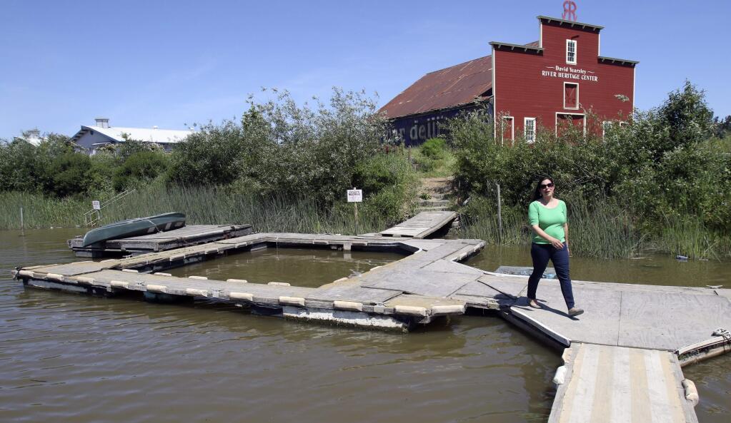 Stephanie Bastianon, Executive Director of Friends of the Petaluma River, walks on makeshift docks that her group is looking to replace with a new permanent launch facility at their River Heritage Center at Steamer Landing Park in Petaluma, on Monday, April 18, 2014. (SCOTT MANCHESTER/ARGUS-COURIER STAFF)