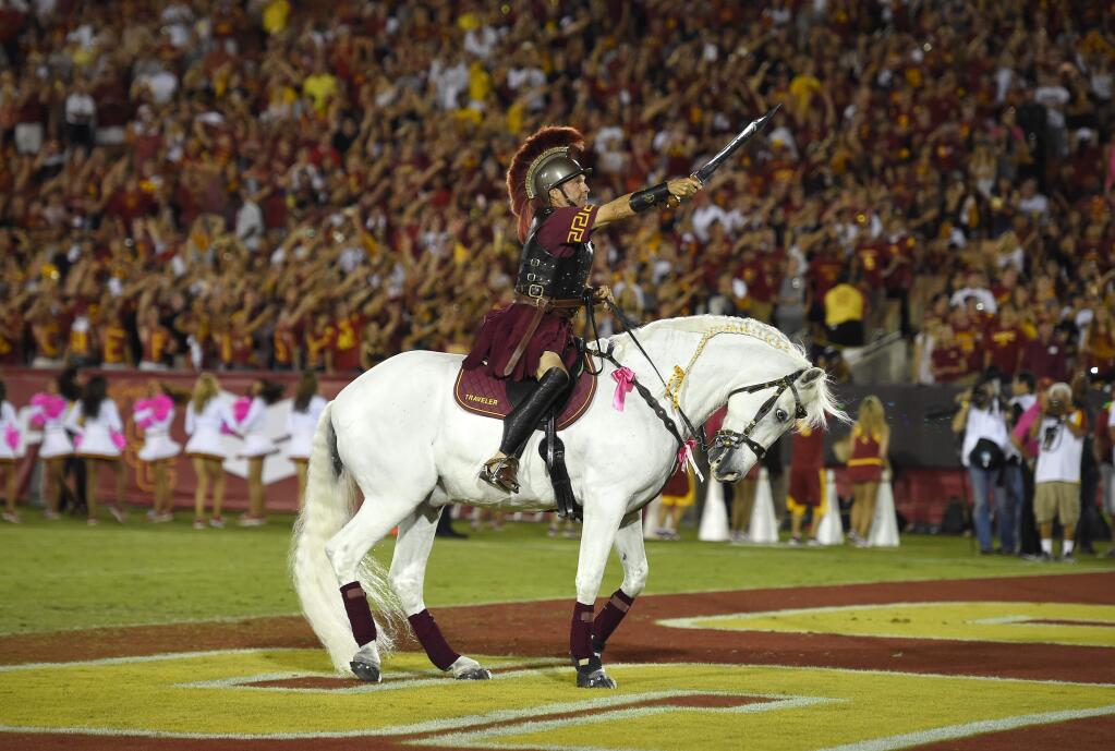Hector Aguilar rides Traveler VII during the second half of a game between USC and Utah, Saturday, Oct. 24, 2015, in Los Angeles. USC won 42-24. (AP Photo/Mark J. Terrill)
