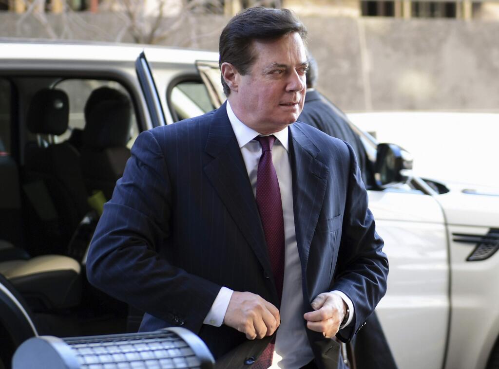 FILE - In this Dec. 11, 2017, file photo, former Trump campaign chairman Paul Manafort arrives at federal court in Washington. Prosecutors in New York City are building a potential criminal case against Manafort, as he awaits sentencing on federal conspiracy and fraud convictions, according to reports published Friday, Feb. 22, 2019. (AP Photo/Susan Walsh, File)