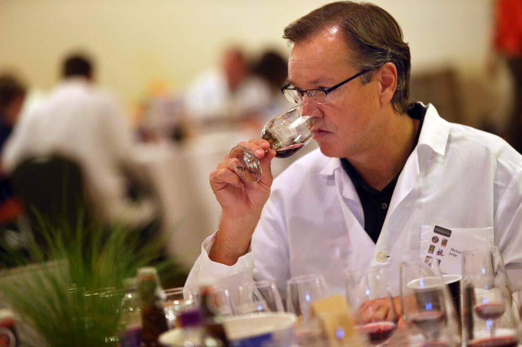 Michael Scholz samples a wine during the 2014 North Coast Wine Challenge. (Christopher Chung/ PD FILE)