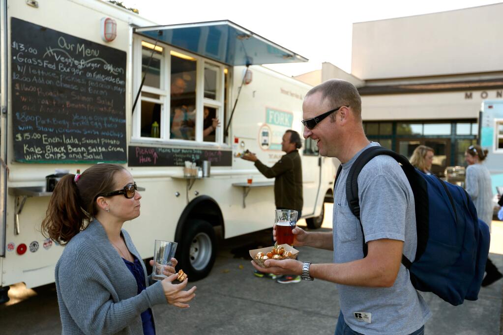 Georgia and Gabriel Dunton enjoy croquettes from the Croques and Toques food truck during the iDrink 4 iPads fundraiser for St. Eugene's Cathedral School in Santa Rosa on Friday, May 20, 2016. (ALVIN JORNADA/ PD FILE)