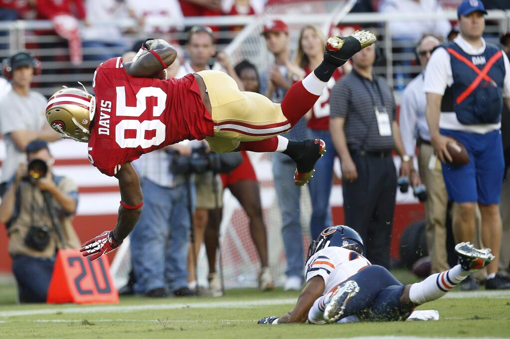San Francisco 49ers tight end Vernon Davis (85) is tackled by Chicago Bears cornerback Kyle Fuller during the second quarter of an NFL football game in Santa Clara, Calif., Sunday, Sept. 14, 2014. (AP Photo/Tony Avelar)