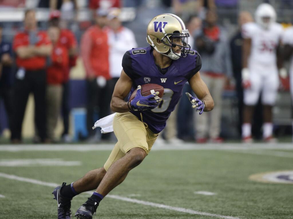 Washington's Dante Pettis returns a punt against Fresno State in the first half of an NCAA college football game Saturday, Sept. 16, 2017, in Seattle. (AP Photo/Elaine Thompson)