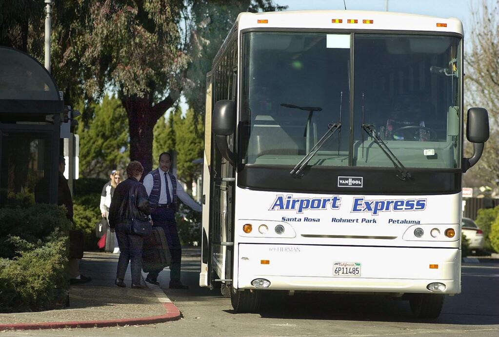 Airport Express bus loads at the terminal building at the Charles M. Schulz Sonoma County Airport.