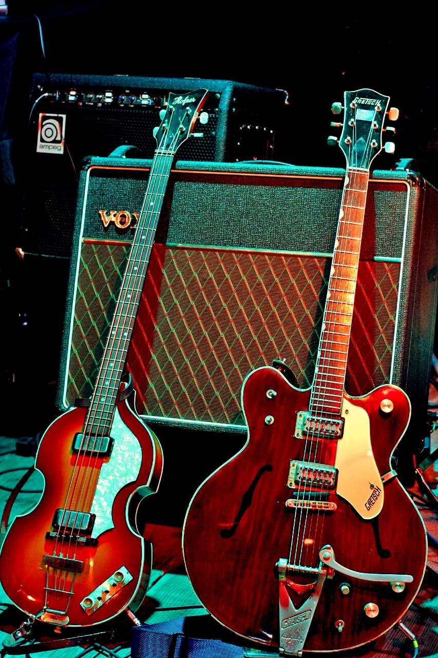 Guitars of Beatles McCartney and Harrison. The band's Apple Corps had a long-running series of trademark lawsuits with Apple Inc., formerly Apple Computers.