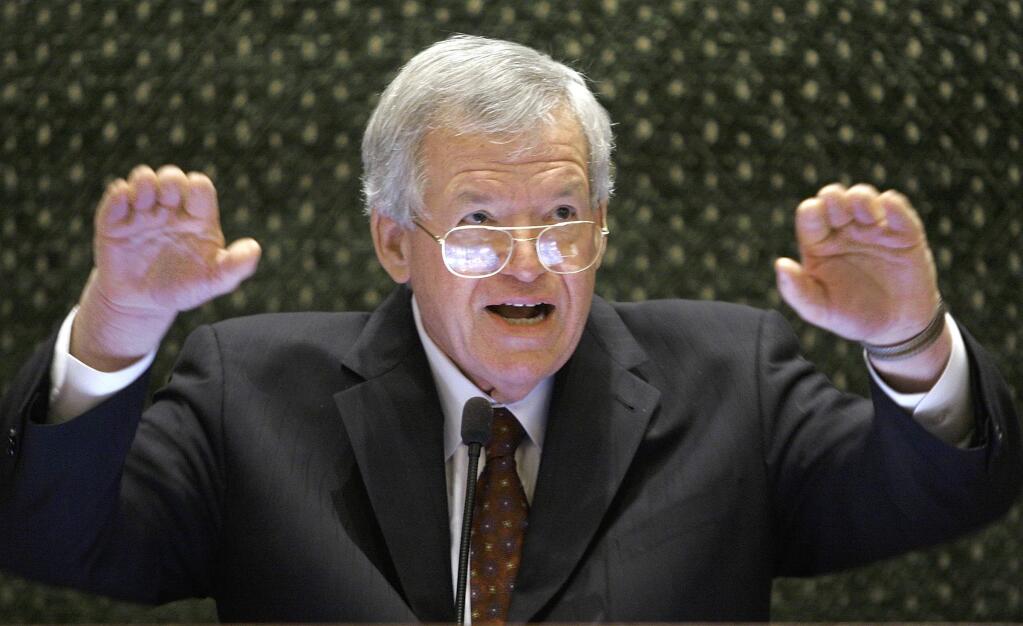 FILE - In this March 5, 2008, file photo, former U.S. House Speaker Dennis Hastert speaks to lawmakers on the Illinois House of Representatives floor at the state Capitol in Springfield, Ill. Federal prosecutors have indicted Thursday, May 28, 2015, the former U.S. House Speaker on bank-related charges. (AP Photo/Seth Perlman, File)