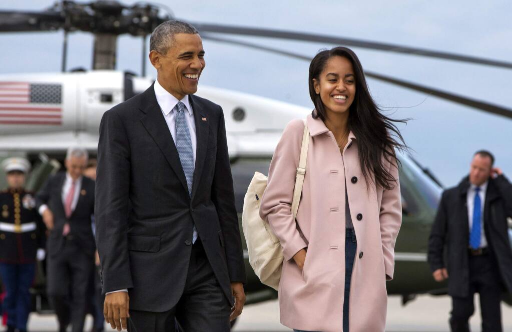 FILE - In a Thursday, April 7, 2016 file photo, President Barack Obama jokes with his daughter Malia Obama as they walk to board Air Force One from the Marine One helicopter, as they leave Chicago en route to Los Angeles. The White House announced Sunday, May 1, 2016, that Malia Obama will take a year off after high school and attend Harvard University in 2017.(AP Photo/Jacquelyn Martin, File)