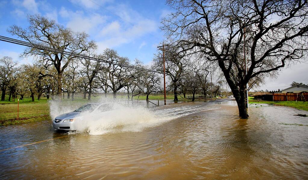Piner Road in Santa Rosa becomes inundated after days of heavy rain, Tuesday Jan. 19, 2016, as storm drains are unable to handle the runoff from already saturated terrain. (Kent Porter / Press Democrat)