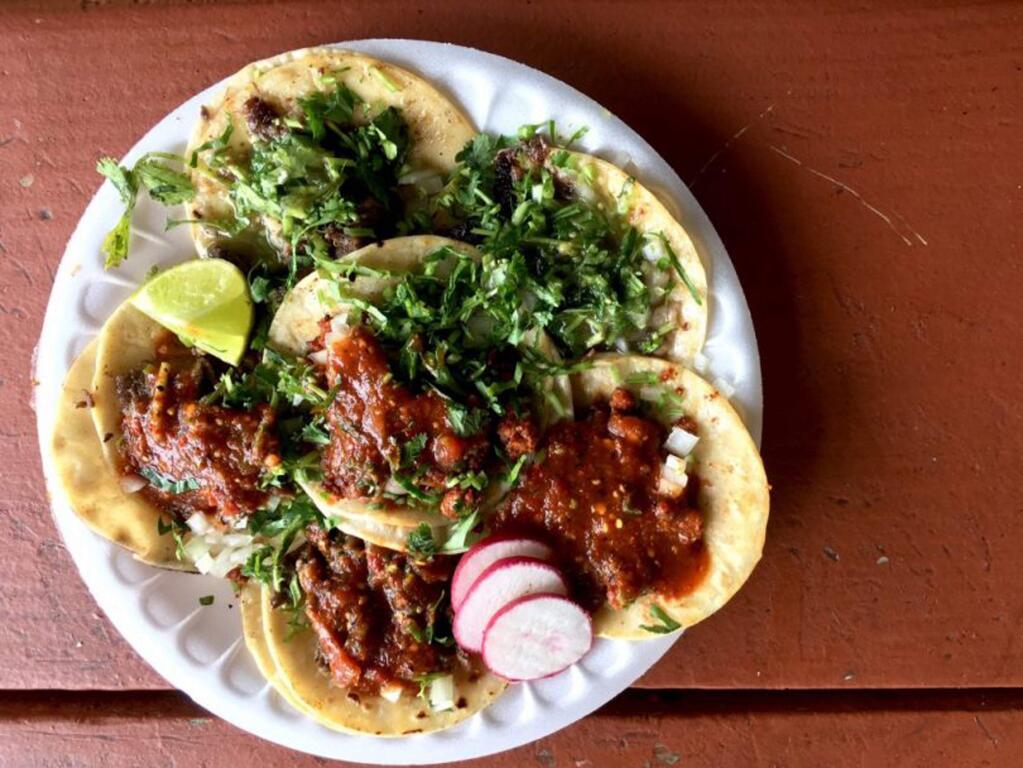Delicias Elenita is right across the street from El Roy's and open after 10:00 pm, just in case a taco craving strikes at a late hour. Elenita has an extensive selection of meats including: Al Pastor, Carnitas, Lengua, Chorizo, Tripa, Buche, Cochinita Pibil and more. The tacos in this photo are diverse, with fresh cut onion and cilantro, sliced red radish. Some come with very spicy habanero salsa, thick red salsa, or a tangy green salsa. The toppings include the traditional grilled onion and jalapeño. 707-526-0881, Sebastopol Road and West Ave, Santa Rosa. (Ricardo Ibarra / La Prensa Sonoma)