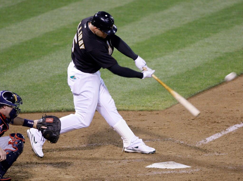 Oakland Athletics' Matt Holliday swings for a grand slam off Minnesota Twins' Bobby Keppel in the seventh inning of a baseball game Monday, July 20, 2009, in Oakland, Calif. (AP Photo/Ben Margot)