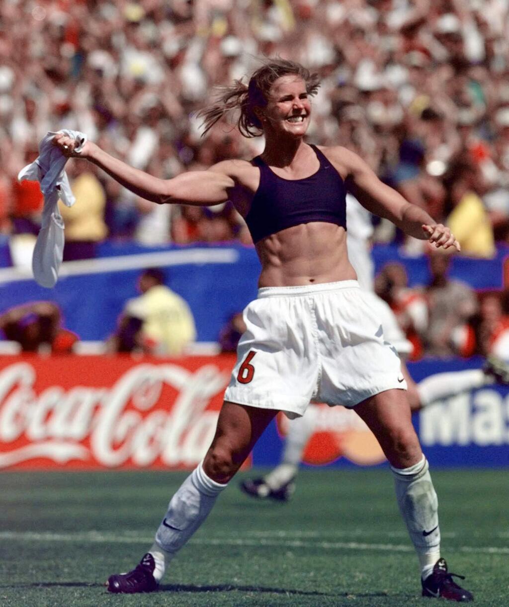 FILE - In this July 10, 1999, file photo, the United States' Brandi Chastain celebrates by taking off her jersey after kicking in the game-winning goal in a penalty shootout against China in the FIFA Women's World Cup Final at the Rose Bowl in Pasadena, Calif. (AP Photo/Mark J. Terrill, File)