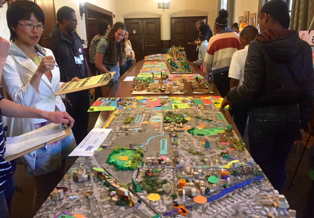 UC Berkeley students and faculty admire the Santa Rosa 2050 model made by fourth gradeers at Cesar Chavez Language Academy. (Courtesty of UC Berkeley YPLAN Project)