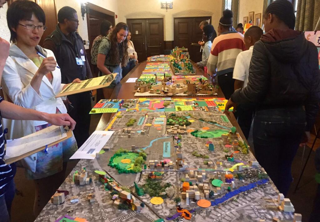 UC Berkeley students and faculty admire the Santa Rosa 2050 model made by fourth gradeers at Cesar Chavez Language Academy. (Courtesty of UC Berkeley YPLAN Project)