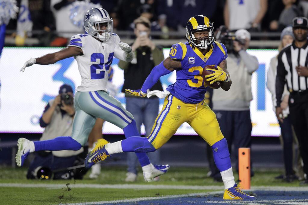 Los Angeles Rams running back Todd Gurley scores past Dallas Cowboys cornerback Chidobe Awuzie during the first half in an NFL divisional football playoff game Saturday, Jan. 12, 2019, in Los Angeles. (AP Photo/Jae C. Hong)