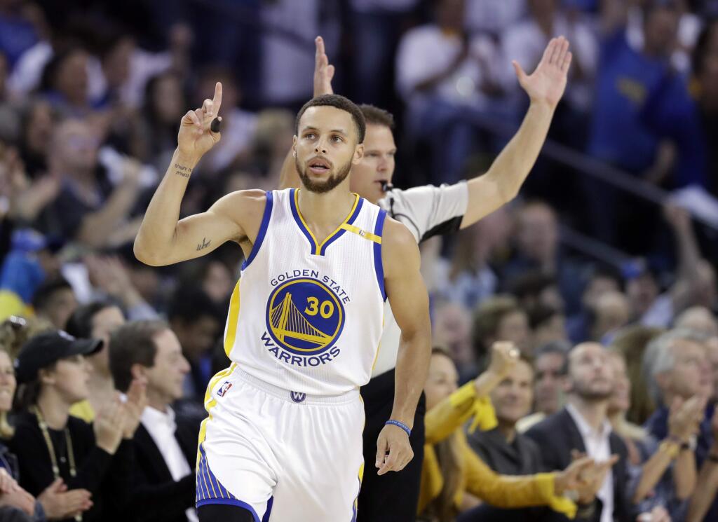 Golden State Warriors' Stephen Curry gestures after making a 3-point basket against the Los Angeles Lakers during the first half Wednesday, April 12, 2017, in Oakland. (AP Photo/Marcio Jose Sanchez)