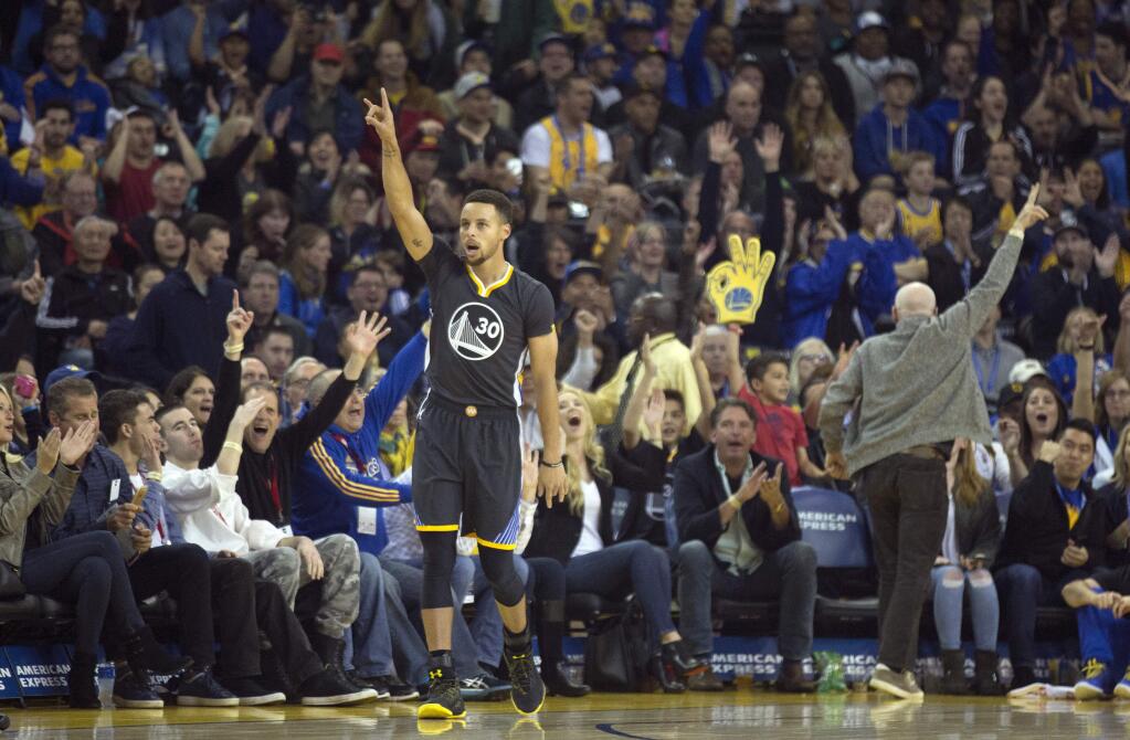Golden State Warriors' Stephen Curry celebrates his 3-point basket against the Minnesota Timberwolves during the first quarter Saturday, Nov. 26, 2016 in Oakland. (AP Photo/D. Ross Cameron)