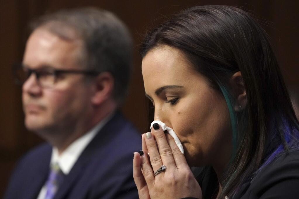 Katherine Posada, right, a teacher at Marjory Stoneman Douglas High School, finishes her testimony about the shooting at the high school, next to Ryan Petty, the father of one of the seventeen students killed there, during a Senate Judiciary Committee hearing on the Parkland, Fla., school shooting and school safety, Wednesday, March 14, 2018, on Capitol Hill in Washington. (AP Photo/Jacquelyn Martin)