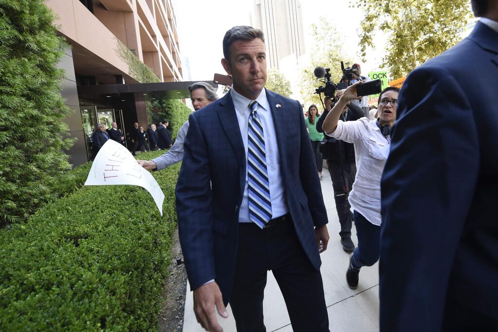 U.S. Rep. Duncan Hunter leaves an arraignment hearing Thursday, Aug. 23, 2018, in San Diego. Hunter and his wife Margaret pleaded not guilty Thursday to charges they illegally used his campaign account for personal expenses. (AP Photo/Denis Poroy)