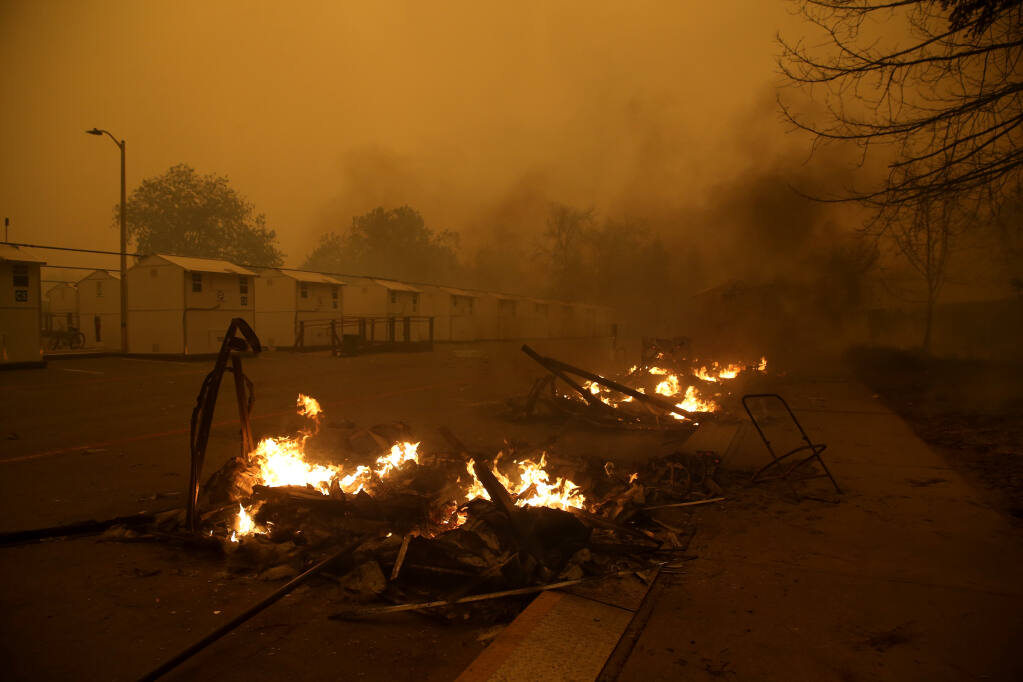 Four temporary housing units for the homeless burn during the Shady fire, later renamed the Glass fire, at Los Guilicos Village in Santa Rosa, Calif., on Monday, Sept. 28, 2020. (BETH SCHLANKER/ The Press Democrat)