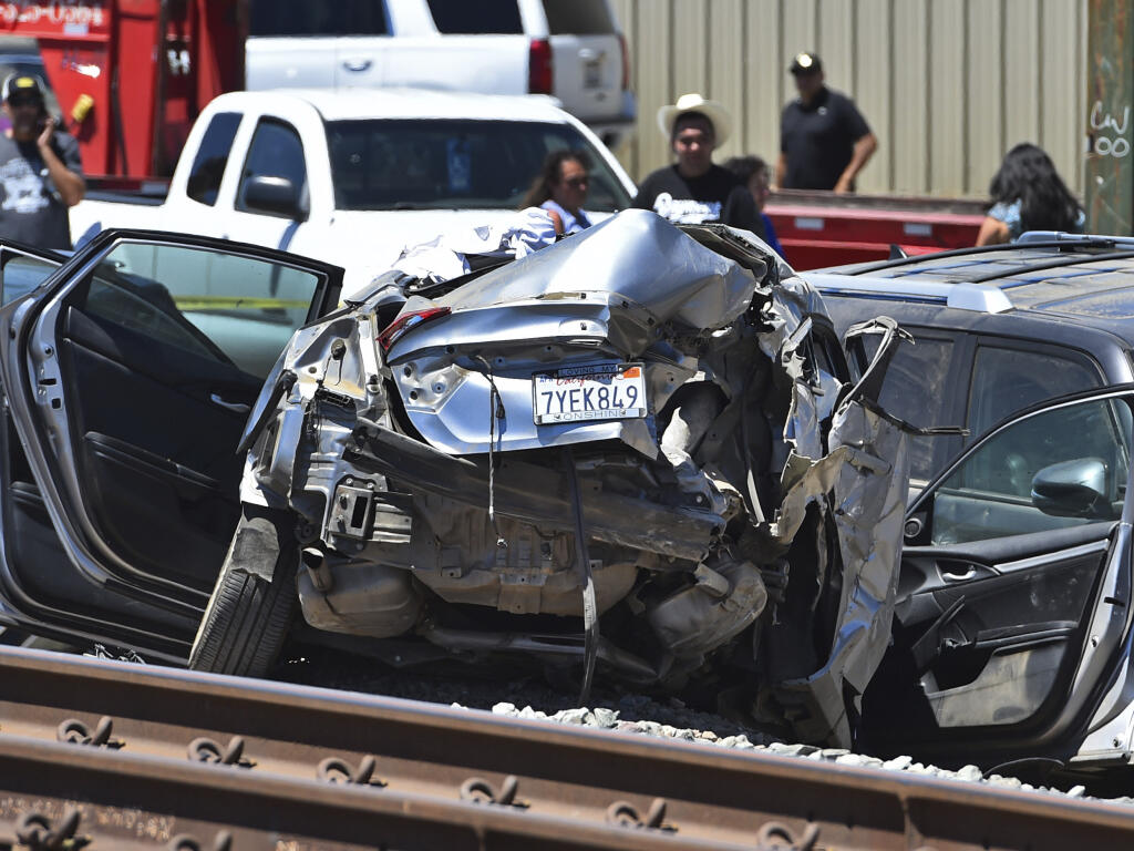 A vehicle is damaged after colliding with an Amtrak train in Brentwood, Calif., on Sunday, June 26, 2022. (Jose Carlos Fajardo/Bay Area News Group via AP)