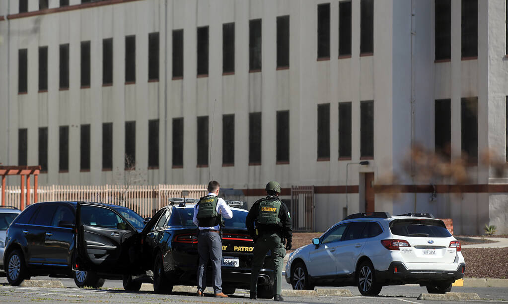 At the Veterans Home of California, Napa County sheriff's officers wait for the last building to be searched before an all clear was given after a report of a gunman on the Yountville campus, Tuesday, March 23, 2021.  (Kent Porter / The Press Democrat)
