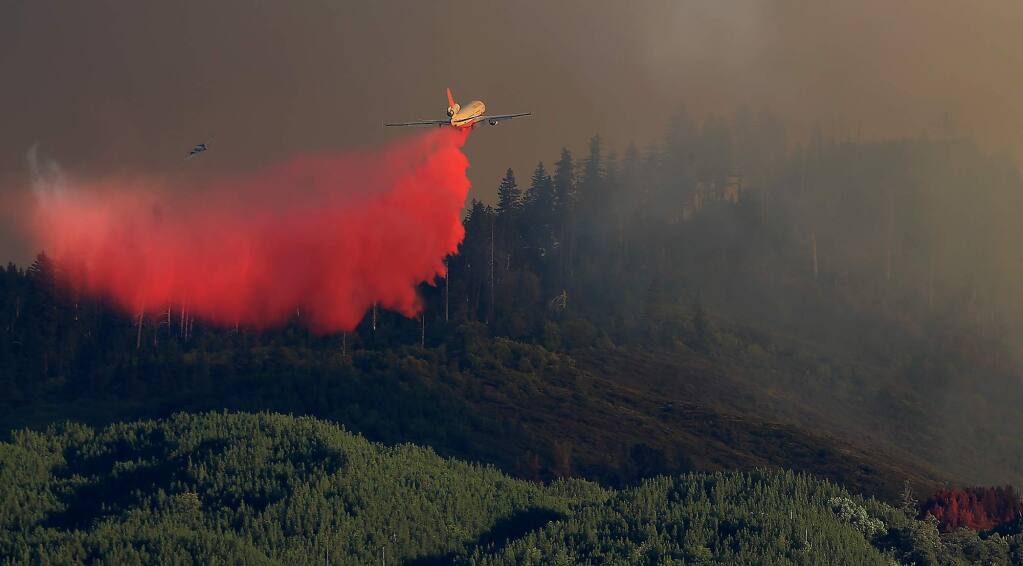 Fire retardant is dropped from the Very Large Air Tanker (VLAT) 910, on the head of the Elk Fire along Pitney Ridge in the Mendocino National Forest, Wednesday Sept. 2, 2015, in Upper Lake just above the Middle Creek drainage. (Kent Porter / The Press Democrat file)