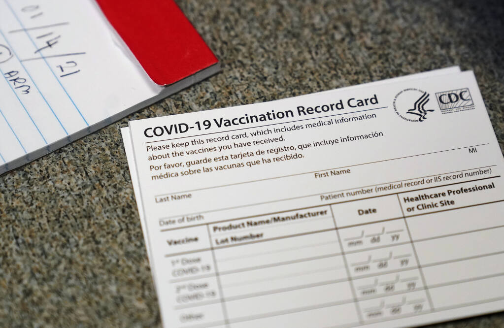FILE - In this Dec. 24, 2020, file photo, a COVID-19 vaccination record card is shown at Seton Medical Center during the coronavirus pandemic in Daly City, Calif. California is offering residents to access a digital record of their coronavirus vaccinations they can use to access businesses or events that require proof of inoculation. The state’s public health and technology departments said Friday, June18, 2021, the new tool will allow Californians to access their record from the state’s immunization registry. (AP Photo/Jeff Chiu, File)