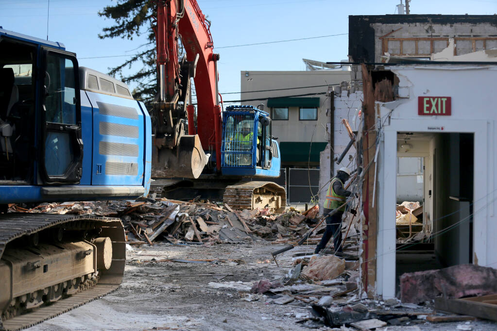 A crew from Hammond Construction work to demolish the building at 420 Mendocino Ave. in Santa Rosa, Monday, March 27, 2023. (Beth Schlanker/The Press Democrat)