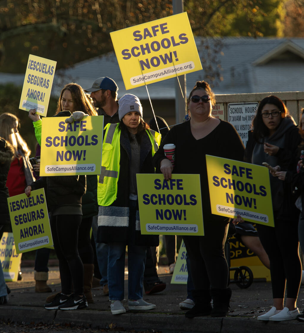 Parents, students and faculty protest Friday morning outside Herbert Slater Middle School concerned about the ongoing problems of fights and weapons on campuses after recent arrests and lockdowns at the Santa Rosa school Friday December 8, 2023.  (Chad Surmick / The Press Democrat)