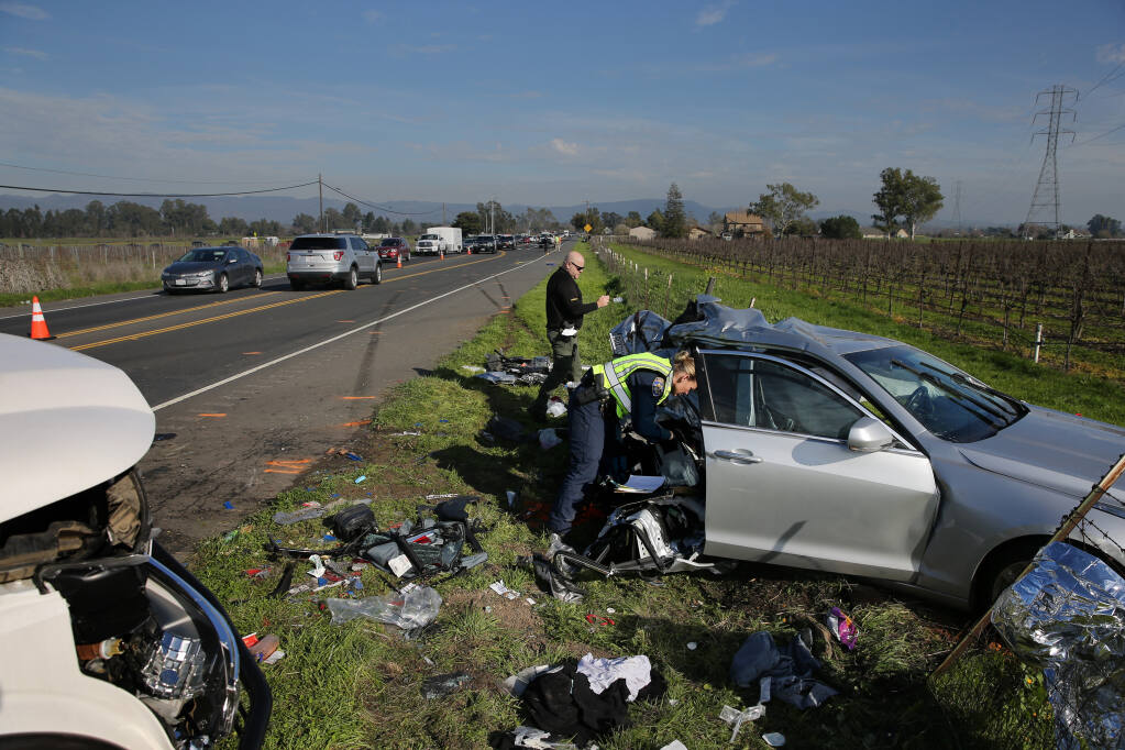 CHP officers investigate the scene of a fatal crash on Highway 116 (Stage Gulch Road), just west of Watmaugh Road, in Sonoma, California, on Sunday, January 16, 2022. (Beth Schlanker/The Press Democrat)