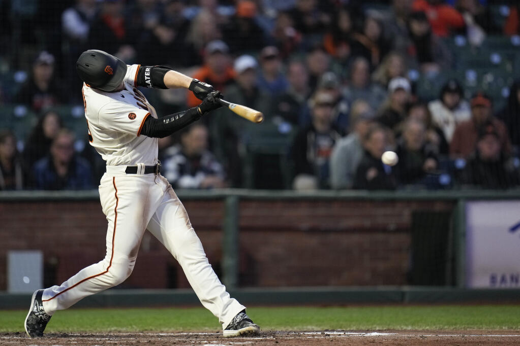 San Francisco Giants' Austin Slater hits an RBI single against the St. Louis Cardinals during the fourth inning of a baseball game in San Francisco, Wednesday, April 26, 2023. (AP Photo/Godofredo A. Vásquez)