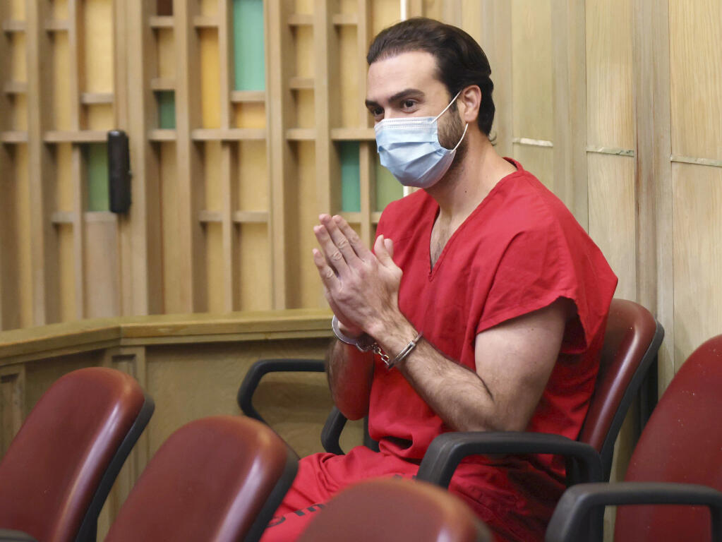 FILE - Pablo Lyle gestures toward family members as they appear in court at the Richard E. Gerstein Justice Building in Miami, on Monday, Dec. 12, 2022. Lyle, accused of fatally punching a driver during a road-rage incident in Miami in 2019, is expected to be sentenced for involuntary manslaughter. (Carl Juste/Miami Herald via AP, Pool, File)