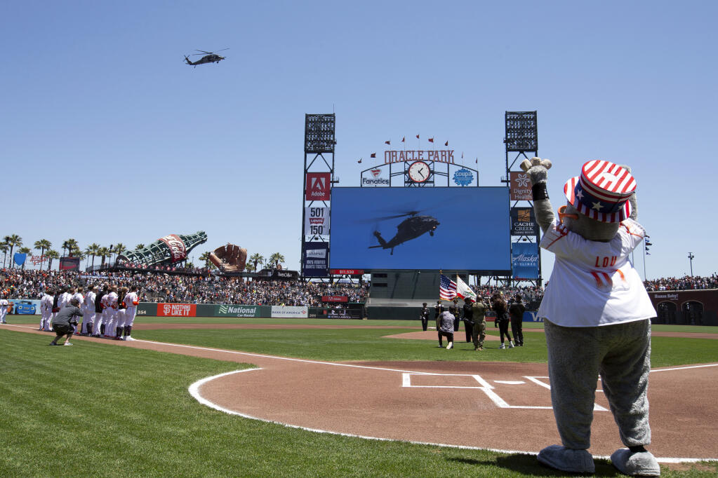 A California Air National Guard helicopter stages a flyover of Oracle Park before a game between the Seattle Mariners and the Giants, Tuesday, July 4, 2023, in San Francisco. (D. Ross Cameron / ASSOCIATED PRESS)