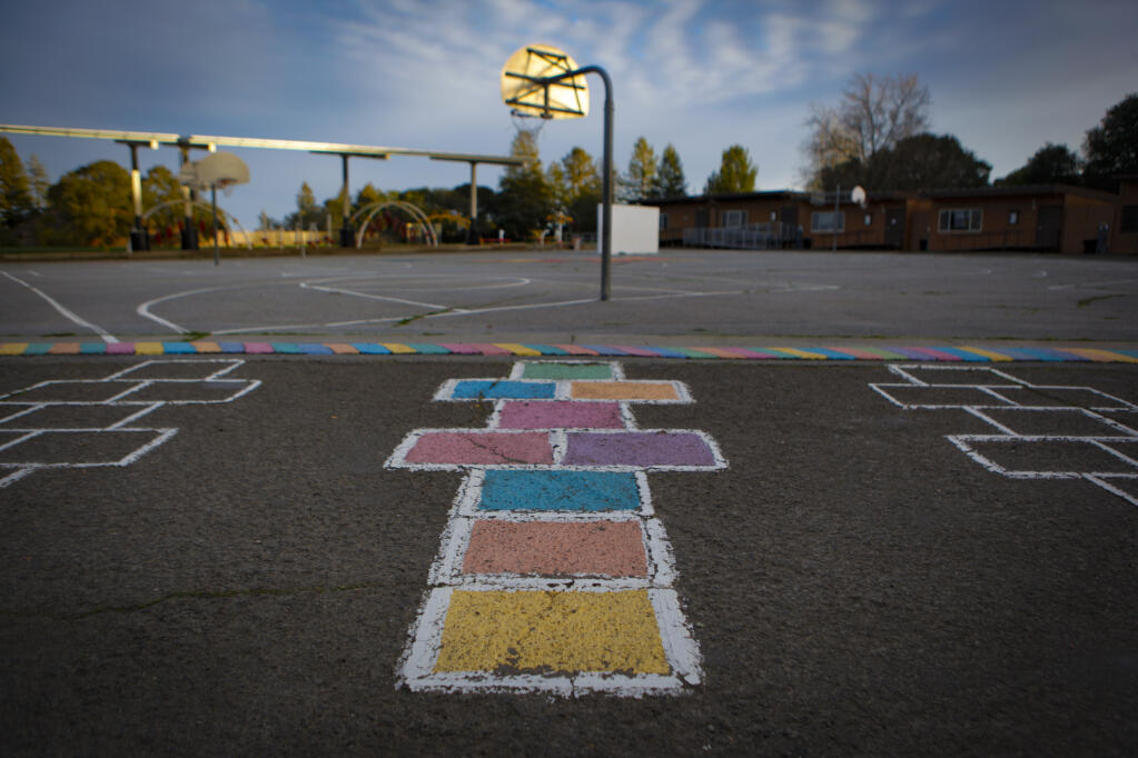 An empty playground sits cloaked in afternoon shadows on Feb. 16, 2021, in Petaluma, California. School campuses in Petaluma remain closed during the COVID-19 pandemic. It has been almost one full year since most students roamed the halls and sat in classrooms but local school boards are taking steps to reopen in the Spring.  (CRISSY PASCUAL/ARGUS-COURIER STAFF)