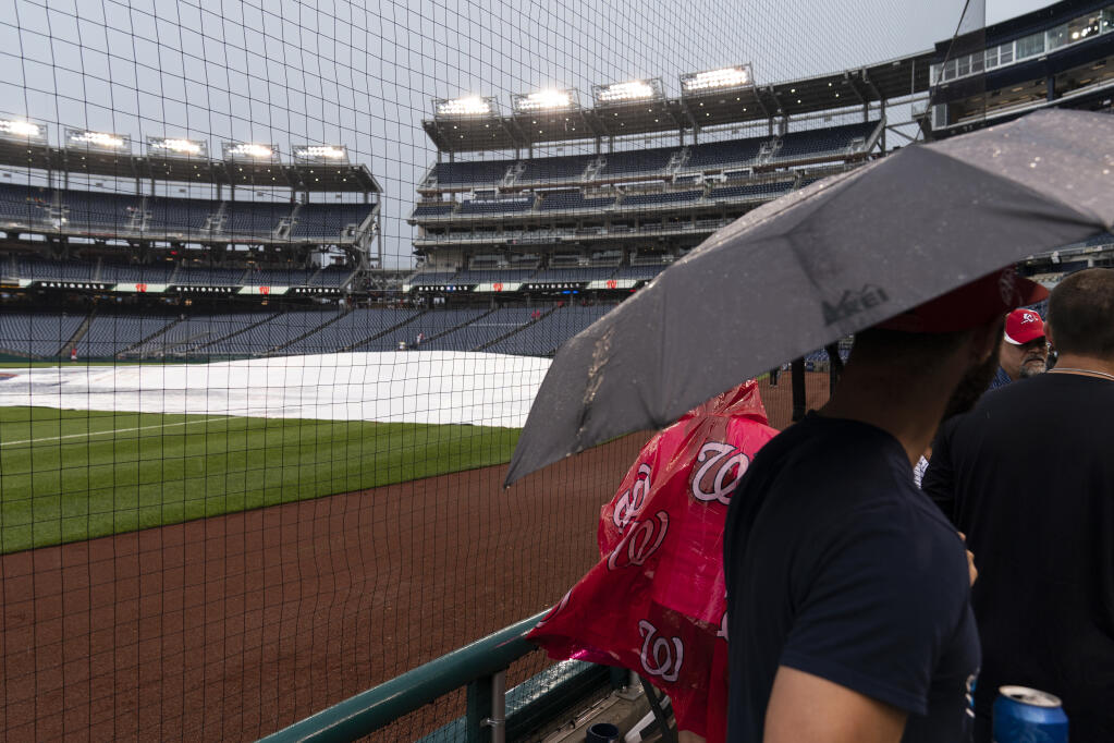 Fans gather to leave a postponed game between the Washington Nationals and the San Francisco Giants at Nationals Park on Thursday, June 10, 2021, in Washington. The game was postponed until Saturday. (Alex Brandon / ASSOCIATED PRESS)