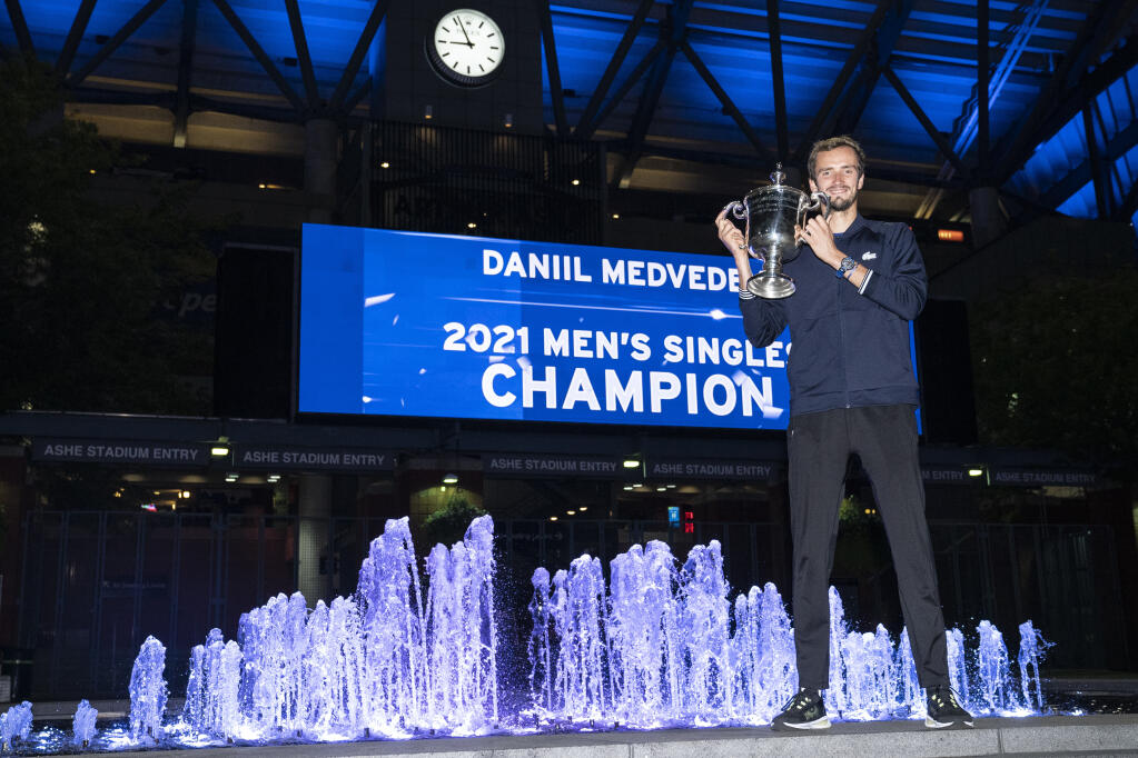 Daniil Medvedev, of Russia, holds up the championship trophy after defeating Novak Djokovic, of Serbia, in the men's singles final of the US Open tennis championships, Sunday, Sept. 12, 2021, in New York. (AP Photo/John Minchillo)