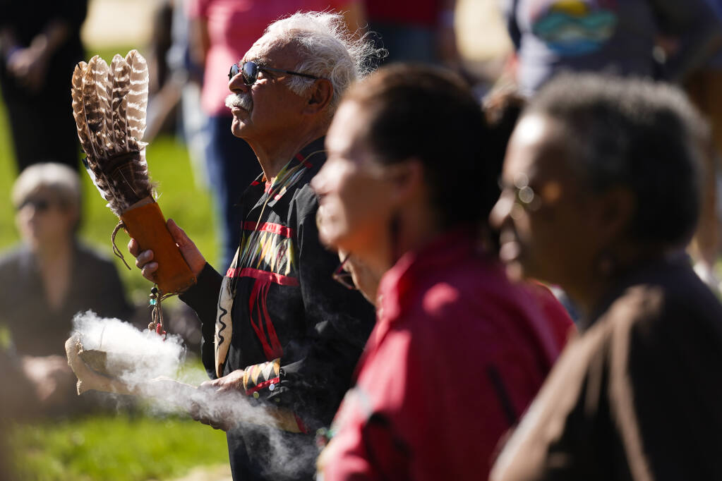 Dave Simon Eagle Hart of the Lenape Nation takes part in a an event to promote healing of the land and community in the aftermath of destruction caused by the remnants of Hurricane Ida, Thursday, Oct. 21, 2021, at Temple University's campus in Ambler, Pa. The Lenape Indian tribe is expected to close early next year on a deal for 11 acres near Fork Branch Nature Preserve in Dover. (AP Photo/Matt Rourke)