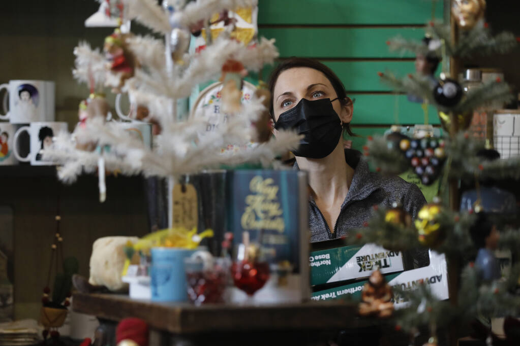 Michelle Rudder shops for Christmas gifts at Heebe Jeebe General Store in Petaluma, Calif., on Thursday, Dec. 16, 2021. (Beth Schlanker/The Press Democrat)