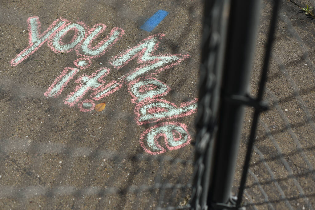 Teachers and staff members filled walkways and playgrounds at Steele Lane Elementary in Santa Rosa with welcoming messages for returning students. (ERIK CASTRO / For The Press Democrat)