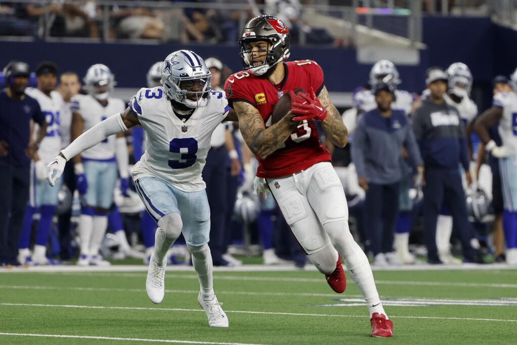 Dallas Cowboys cornerback Anthony Brown (3) defends as Tampa Bay Buccaneers wide receiver Mike Evans (13) catches a pass in the second half of a NFL football game in Arlington, Texas, Sunday, Sept. 11, 2022. (AP Photo/Michael Ainsworth)