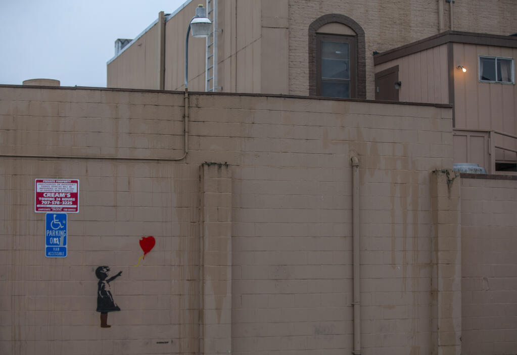 Street art signed by renowned artist Banksy, though not confirmed, seen Saturday, Dec. 3, on the back of Masonic Lodge 181 in Windsor, is thought to have appeared overnight Thursday. Dec. 1, 2022. (Chad Surmick/The Press Democrat)