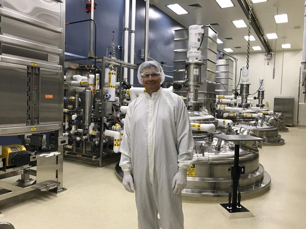 Tony Pankau, vice president and general manager at Genentech's Vacaville campus, shows off clean room in the second cell-culture plant, CCP2. Bioreactors, like those behind him, grow mammalian cells for medical applications. (GARY QUACKENBUSH / FOR NORTH BAY BUSINESS JOURNAL) June 2017
