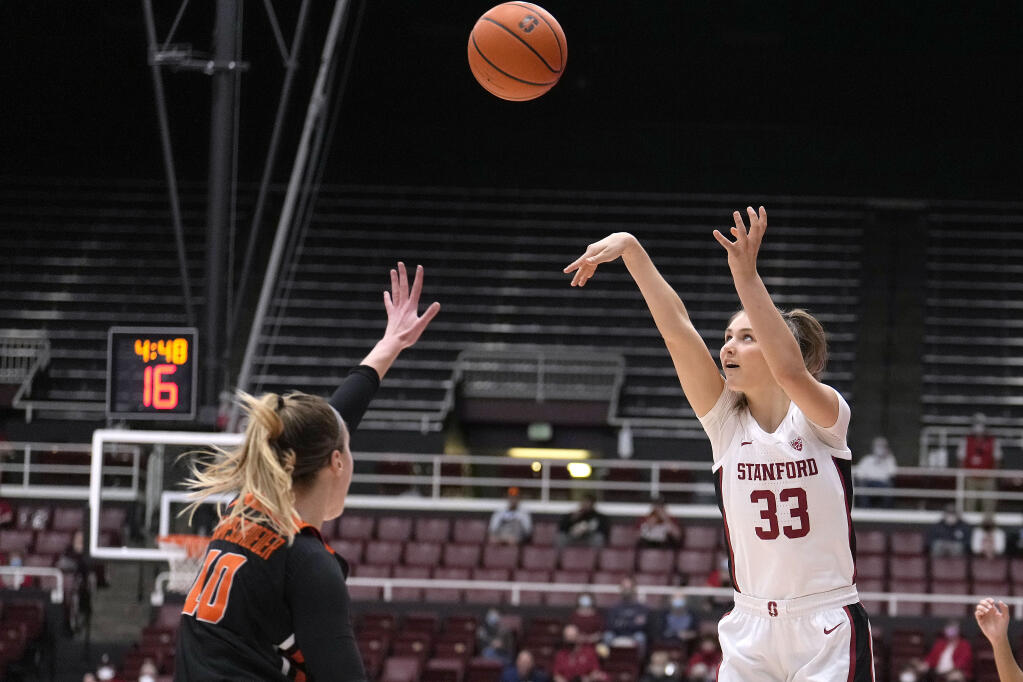 Stanford guard Hannah Jump, right, takes a 3-point shot over Oregon State guard Greta Kampschroeder during the first half in Stanford on Wednesday, Feb. 9, 2022. (Tony Avelar / ASSOCIATED PRESS)