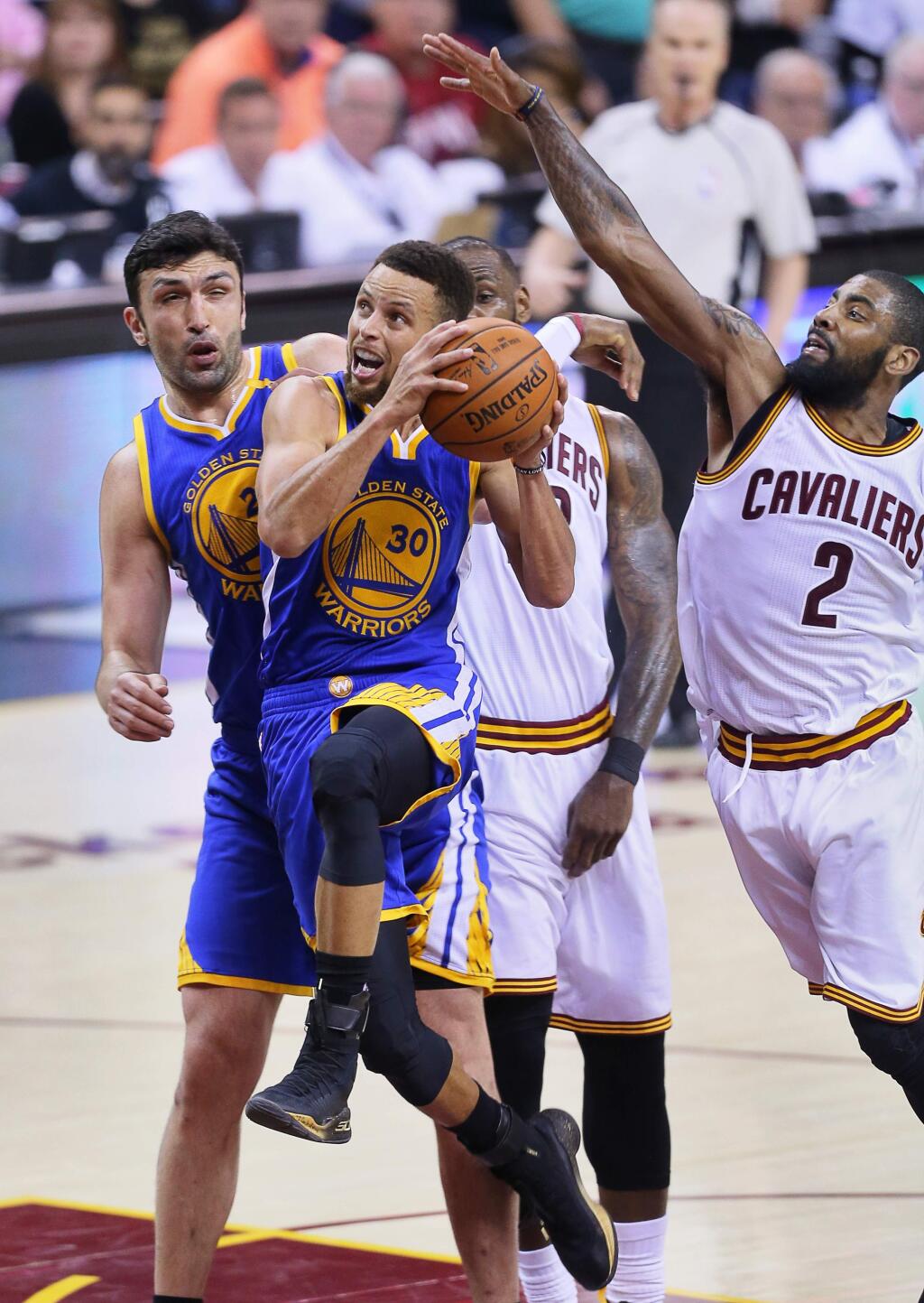 Golden State Warriors guard Stephen Curry goes to the basket against Cleveland Cavaliers guard Kyrie Irving during Game 4 of the NBA Finals in Cleveland on Friday, June 9, 2017. (Christopher Chung/ The Press Democrat)