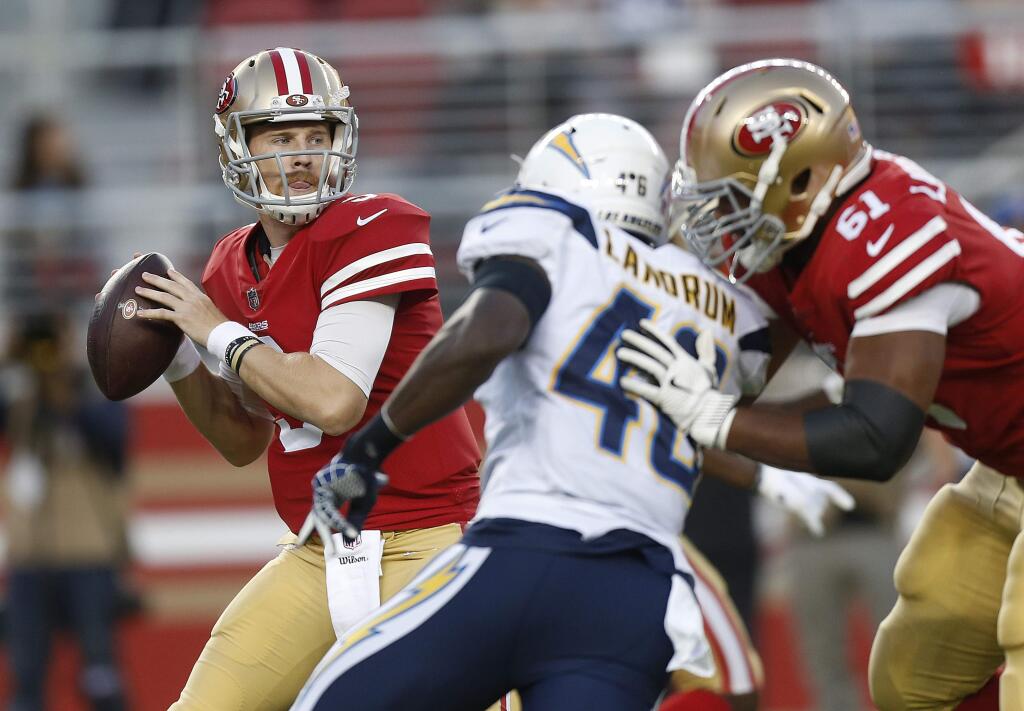 In this Aug. 30, 2018, file photo, San Francisco 49ers quarterback C.J. Beathard, left, passes against the Los Angeles Chargers during the first half of a preseason game in Santa Clara. (AP Photo/Josie Lepe, File)