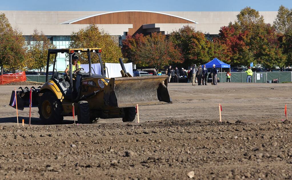 An excavator continues preliminary work at the site of a new Kaiser Permanente medical office facility, following a groundbreaking ceremony, in southwest Santa Rosa, on Friday, November 18, 2016. Kaiser Permanente will also occupy office space in an existing building, seen in the background.(Christopher Chung/ The Press Democrat)