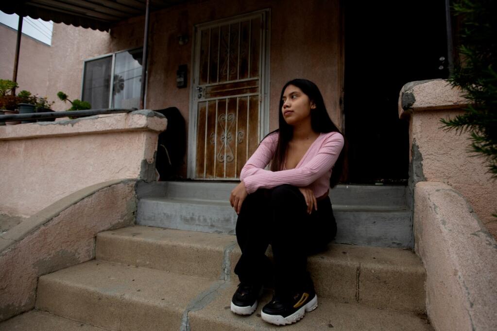 Evelyn Flores is photographed in front of her home in Los Angeles on April 22, 2021. Evelyn was unable to connect to certain websites, including some college application pages, while using the hotspot provided by her school district Photo by Shae Hammond for CalMatters