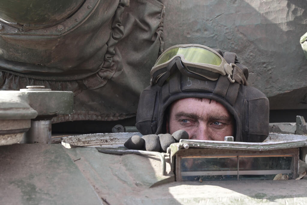 A Ukrainian serviceman looks out from a tank in the village of Lukyanivka, Kyiv region, Ukraine, Sunday, March 27, 2022. (AP Photo)