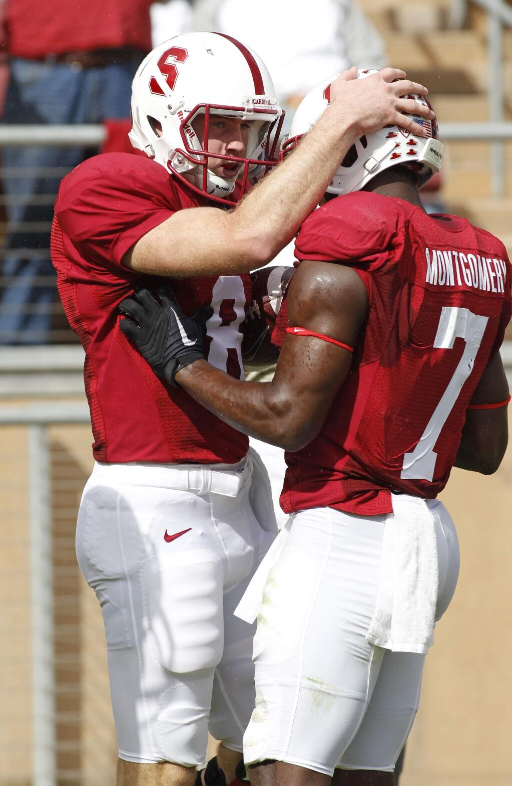 Stanford quarterback Kevin Hogan, left, celebrates with Ty Montgomery after scoring a touchdown against Oregon State during the first half of an NCAA college football game, Saturday, Oct. 25, 2014, in Stanford. (AP Photo/George Nikitin)